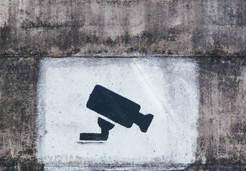 A painting on a wall warning visitors about video surveillance