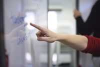 Person pointing at whiteboard